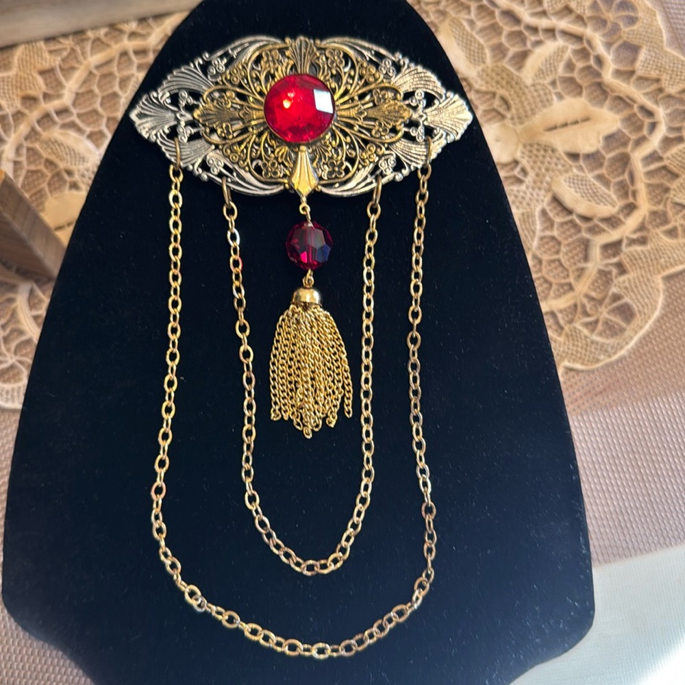 Ornate festoon tassel & chain hanging brooch with faux ruby stones